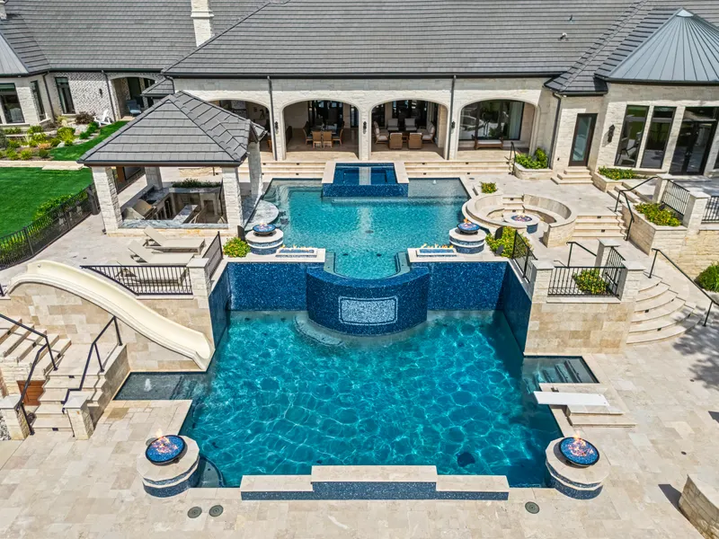 Two-level resort pool with slide, fire bowls and sunken outdoor kitchen at Bella Terra Estate, Parker TX