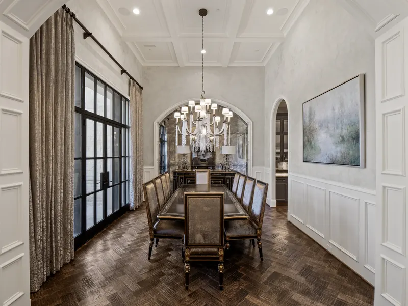 Formal dining room with coffered ceiling, chandelier and herringbone wood floor