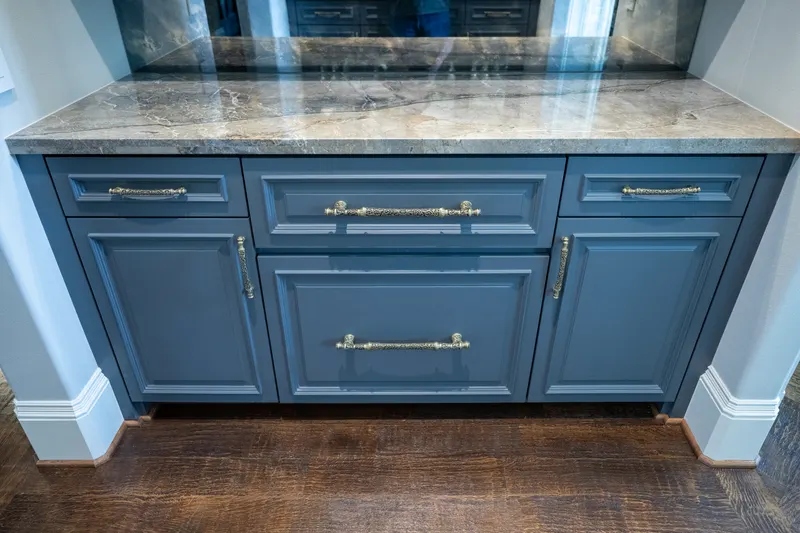 Butler's serving cabinet in slate blue with stone counter and mirrored back