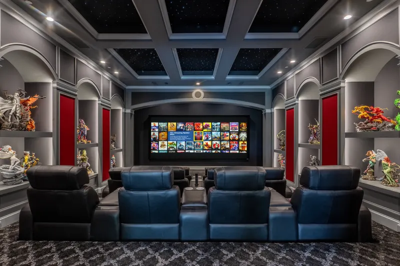 Home theater with starlit coffered ceiling and tiered leather recliner seating