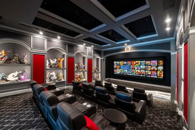 Home theater side view with lit display niches and a wide projection screen