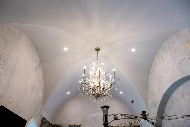 Master suite groin-vault ceiling detail with a crystal branch chandelier