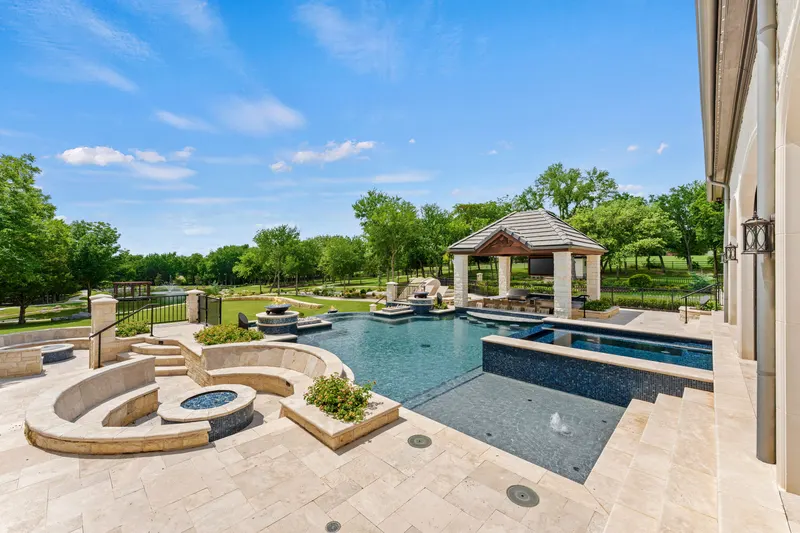 Resort pool with sunken fire pit, raised spa and swim-up bar cabana at Bella Terra Estate, Parker TX