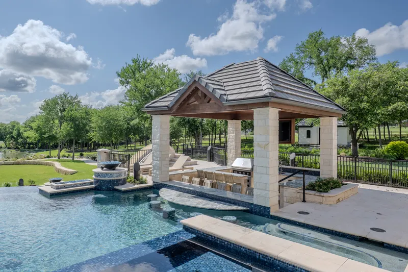 Swim-up bar and sunken outdoor kitchen under the poolside cabana at Bella Terra Estate, Parker TX