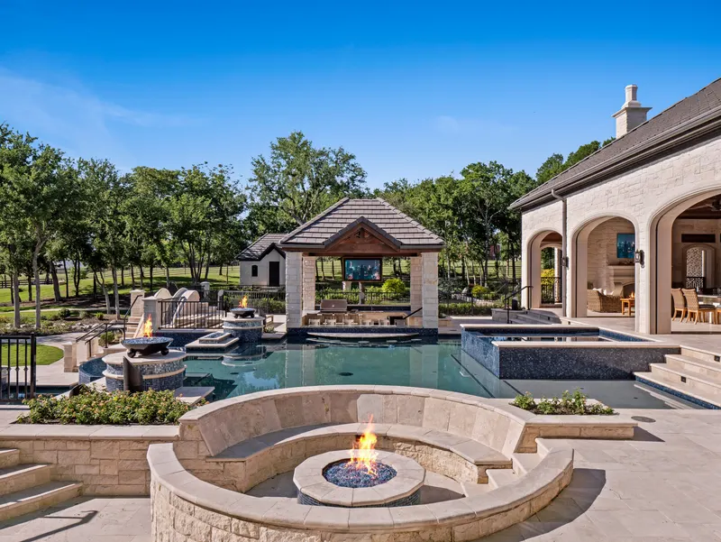 Curved sunken fire pit lounge overlooking the resort pool and cabana at Bella Terra Estate, Parker TX