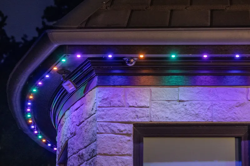 Close-up of permanent LED eave lighting and a dome security camera at Bella Terra Estate, Parker TX