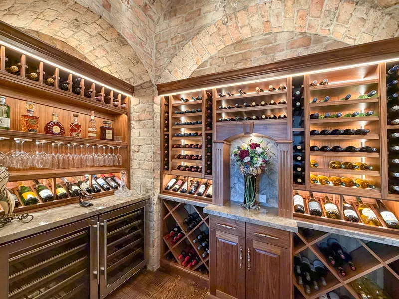 Wine room counter with stemware rack, spirits shelf and diamond bottle bins